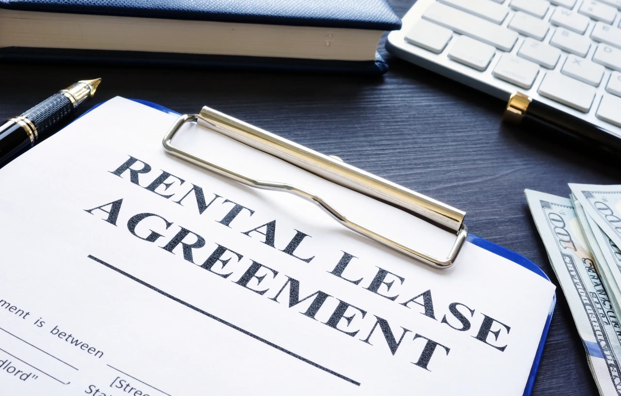 Rental lease agreement and property management documents organized on desk
